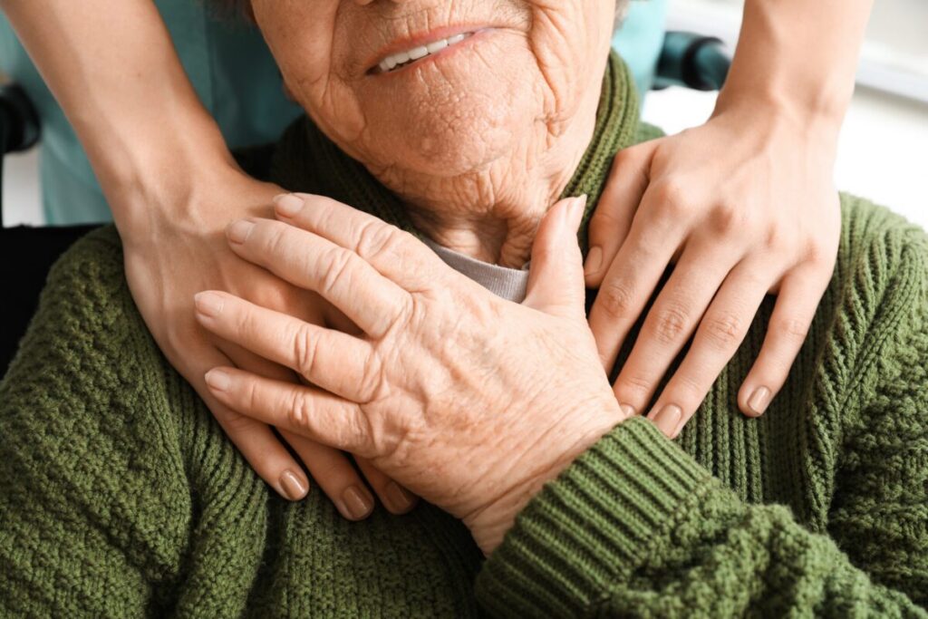 Hands on shoulders emphasizing The Importance of Emotional Support in Senior Living